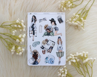 May include: A sheet of stickers featuring illustrations of women traveling. The stickers include images of women with suitcases, sunglasses, hats, and a passport. The text "Travel Girls" is printed at the top of the sheet.