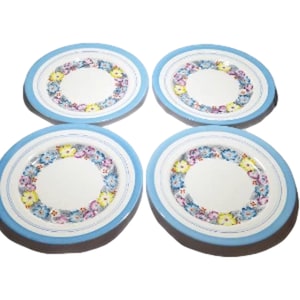 Presenting a beautiful set of Royal Albert Crown China plate titled "Dorothy". These porcelain plates measures 7 7/8" in diameter. It has a colorful wreath of assorted embossed colorful flowers and a blue border on a white background.