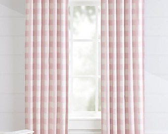 May include: Two pink and white gingham patterned curtains hanging in a window.