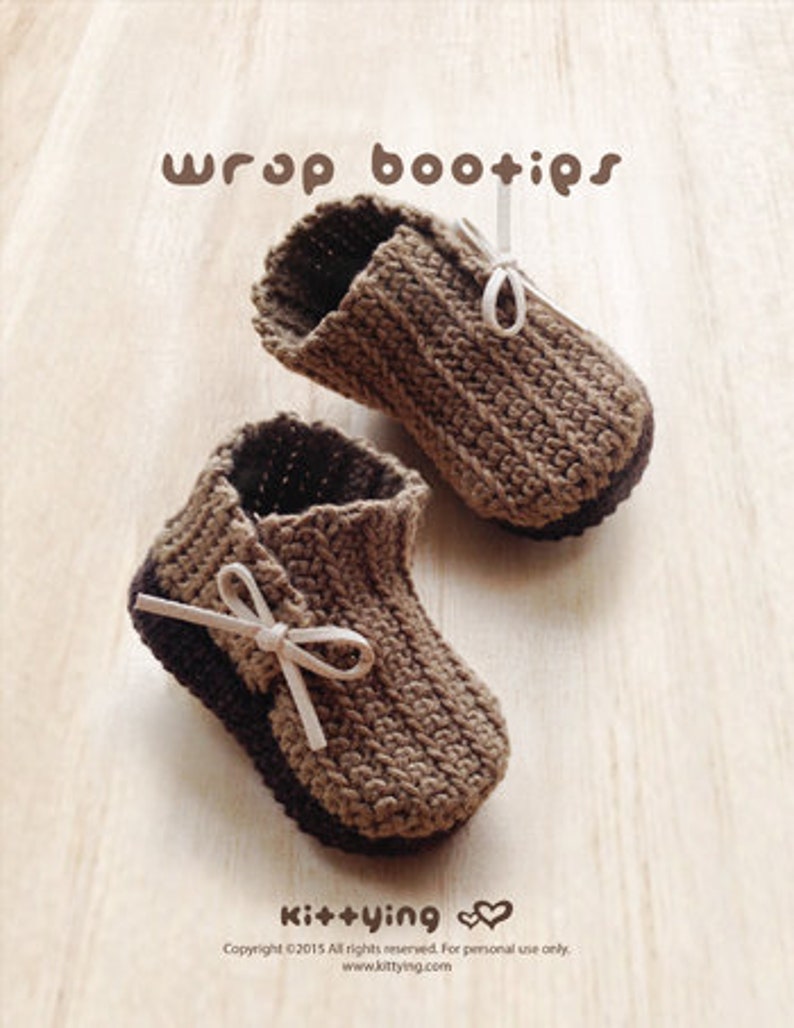 May include: A pair of brown crocheted baby booties with white ribbon ties. The booties have a wrap design and are made with a textured stitch.