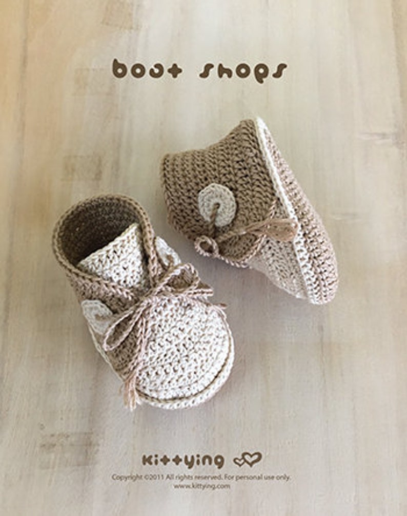 May include: A pair of crocheted baby booties in beige and white with a button detail. The booties are called "boot shops" and are made by Ki++ying.