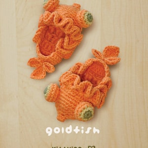 May include: Two handmade, orange crochet goldfish slippers. The slippers have ruffled edges, fins, and green and yellow accents. The word "goldfish" is written in white script below the slippers.
