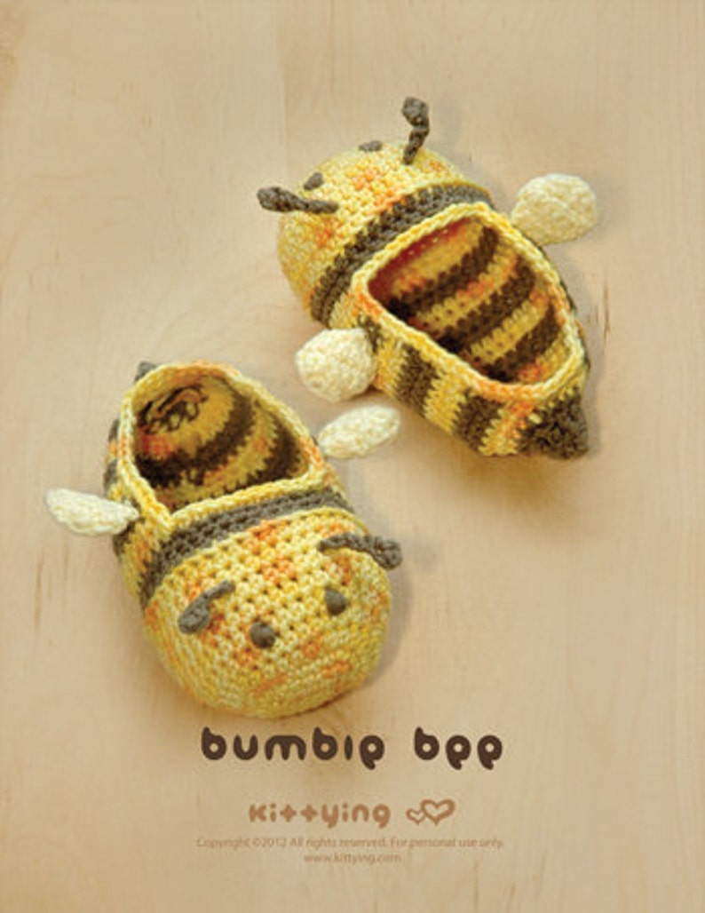 May include: A pair of crocheted bee-shaped slippers in yellow and brown. The slippers have black eyes and a striped pattern.