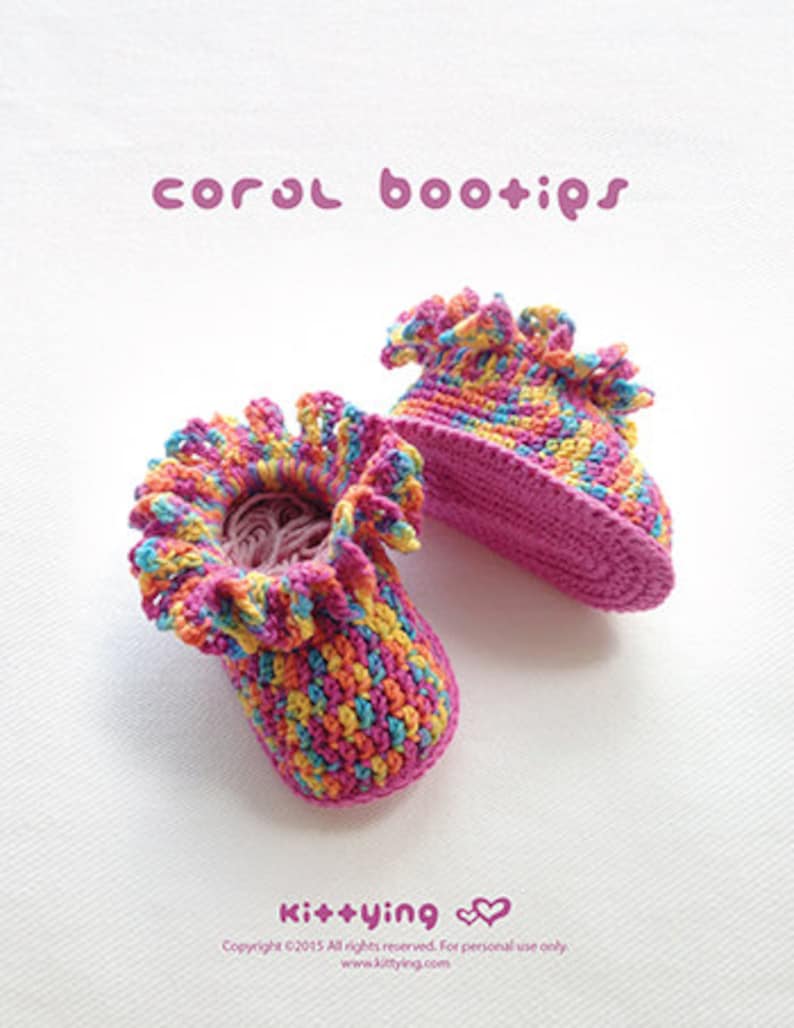 May include: A pair of colorful crocheted baby booties with a pink base and a ruffled edge. The booties are made with a variety of colors, including pink, yellow, blue, and orange. The text "coral bootips" is written in pink letters at the top of the image. The text "Kit+ying" is written in pink letters at the bottom of the image.