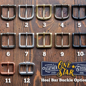 May include: Twelve different metal buckle options for a leather strap. The buckles are arranged in rows of three, with each row labeled with a number from 1 to 12. The buckles are made of different metals, including silver, gold, brass, and black.