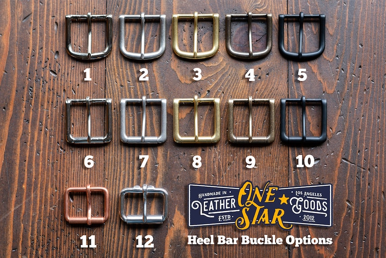 May include: Twelve different metal buckle options for a leather strap. The buckles are arranged in rows of three, with each row labeled with a number from 1 to 12. The buckles are made of different metals, including silver, gold, brass, and black.