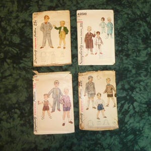 May include: Four vintage sewing patterns for boys' clothing. The patterns are Simplicity 4250, Simplicity 252, Simplicity 252, and Simplicity 252. The patterns feature illustrations of boys wearing different styles of clothing, including shirts, pants, and jackets.