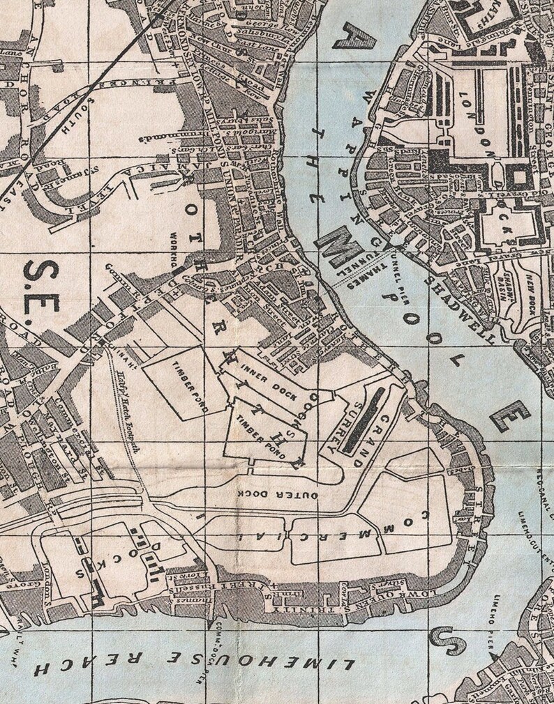 May include: A vintage map of the Thames River in London, England, showing the docks and surrounding areas. The map is printed in black and white on a light blue background. The map includes the names of various docks, including the "Inner Dock", "Outer Dock", "Commercial Dock", and "Surrey Dock". The map also includes the names of various streets and roads, including "Shadwell", "Wapping", and "Limehouse Reach".