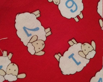 Red cotton fabric with numbered sheep