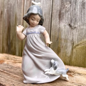 Lladro Nao Porcelain Figurine of Dancing Girl with Playful Puppy, Made in Spain, Muted Colour Scheme, White Bow, Grey Dress, 1988