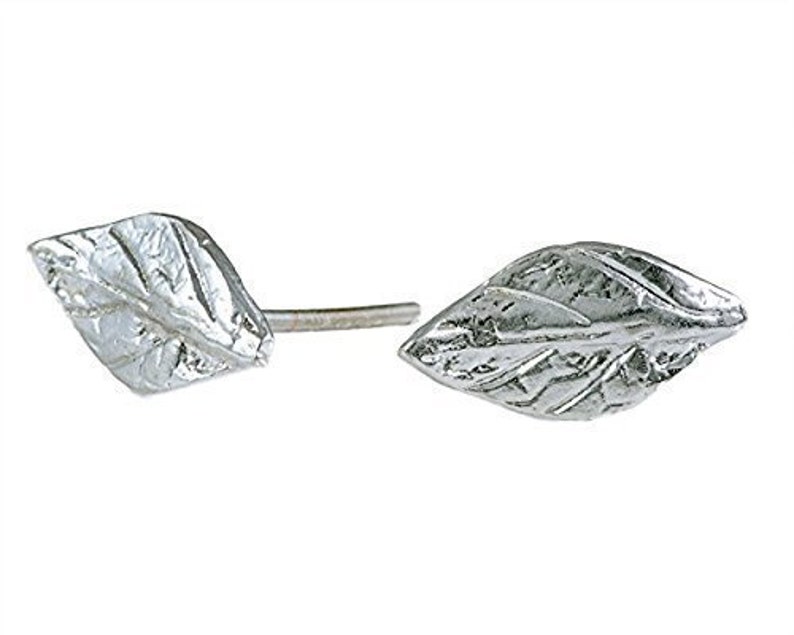 May include: A pair of silver leaf stud earrings. The leaves are textured and have a slightly diamond shape.