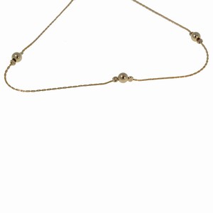 May include: A delicate gold chain necklace with small round beads. The chain is thin and has a braided design.