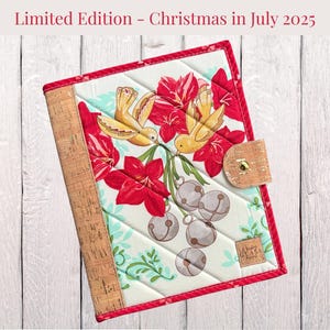 May include: Quilted journal with a cork spine and a flap closure. The cover features a design of yellow birds, red flowers, and silver bells. The text "Limited Edition - Christmas in July 2025" is at the top.
