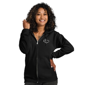 May include: Black zip-up hoodie with a white embroidered logo of two stylised ears on the left chest.