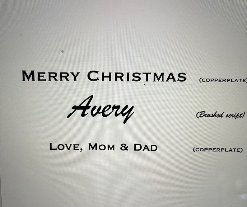 May include: Black text on a light background reads MERRY CHRISTMAS in copperplate font, Avery in a brushed script font, and LOVE, MOM & DAD in copperplate font. Labels to the right indicate (COPPERPLATE) and (Brushed script).