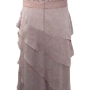May include: A mauve lace top with a layered chiffon skirt. The dress has a scoop neckline and short sleeves.