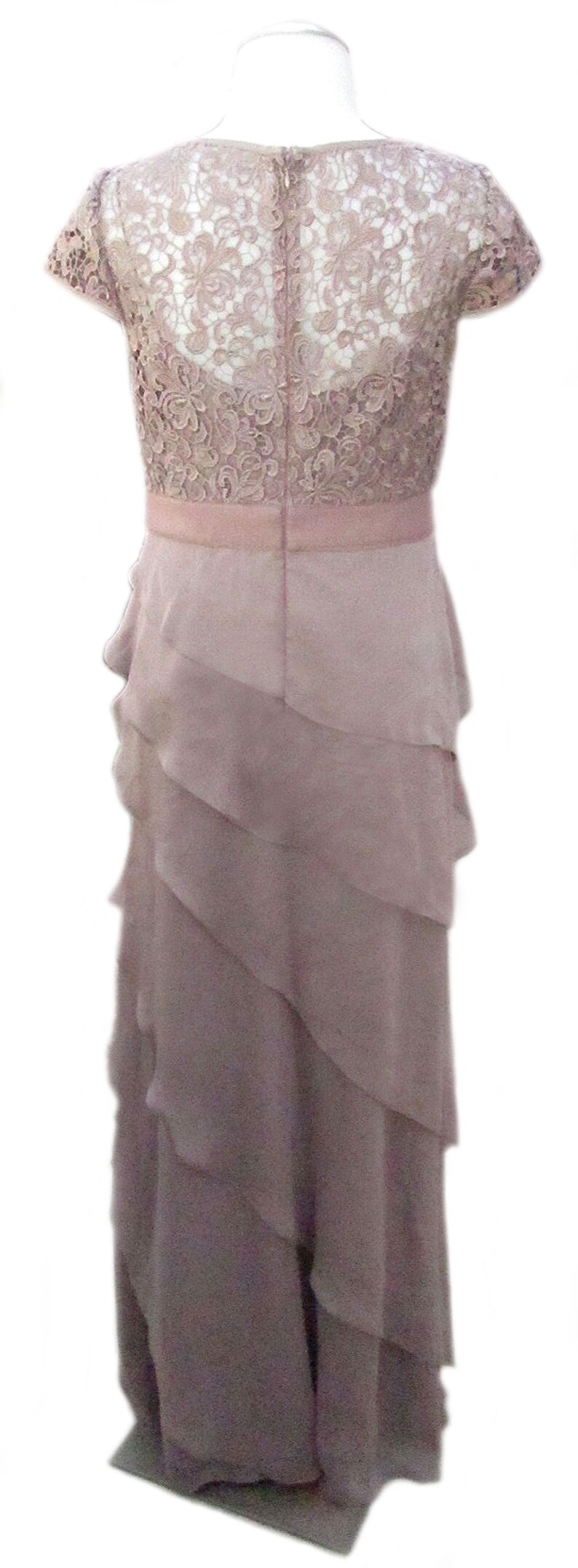 May include: A mauve lace top with a layered chiffon skirt. The dress has a scoop neckline and short sleeves.