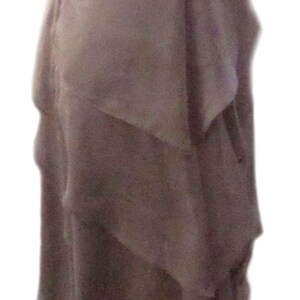 May include: A mauve lace and chiffon maxi dress with a ruffled skirt. The dress has a fitted bodice and a wide lace band at the waist.