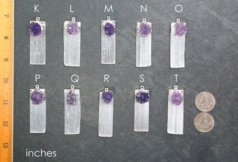 May include: Ten selenite crystal pendants with amethyst clusters, labeled K through T. Each pendant is approximately 1.5 inches long and features a silver bail.