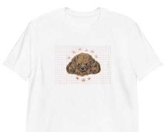May include: White t-shirt with a brown poodle illustration on a grid background with pink stars.
