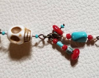 Southwest inspired skull charm with Turquoise and coral charms.