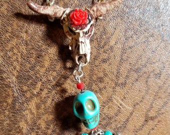 Southwest inspired hand painted cow skull and charms.