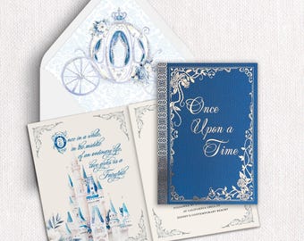 May include: A blue and cream wedding invitation suite featuring a carriage illustration on the envelope liner, a castle graphic with the text Once in a while, in the middle of an ordinary life, love gives us a Fairytale, and a blue card with Once Upon a Time.
