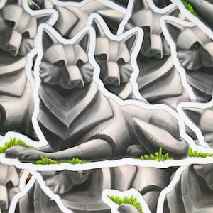 May include: A set of gray wolf stickers with a detailed, stylized design. The wolves are depicted in a lying down position with a grassy background.