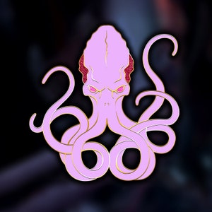 Puede incluir: Un pulpo rosa con ojos de purpurina roja. El pulpo tiene ocho tentáculos y está en posición enroscada.