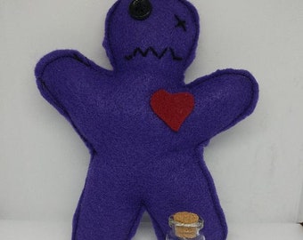Voodoo doll with bottle of pins and instructions