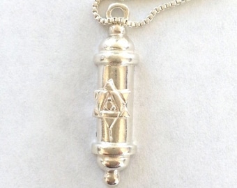 May include: Silver pendant necklace featuring a silver scroll with a Star of David design.