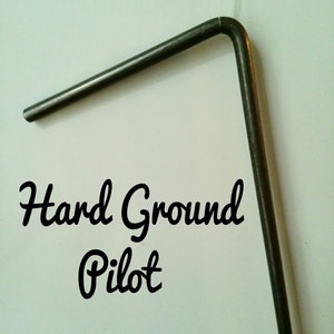 May include: A metal tool with a bent end, labeled "Hard Ground Pilot".