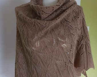 May include: A brown knitted shawl with a delicate lace pattern. The shawl is draped over a mannequin and has a scalloped edge.