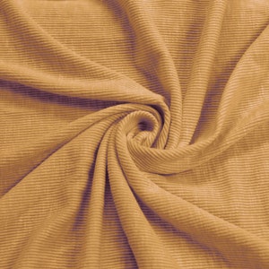 May include: Close-up of a brown ribbed fabric with a swirling pattern.