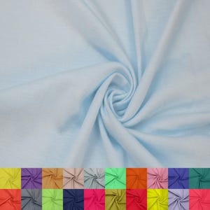 May include: A close-up of a light blue fabric with a soft, flowing texture. The fabric is swirled, creating a dynamic pattern. Below, a color palette of various fabric swatches in different colors is displayed.