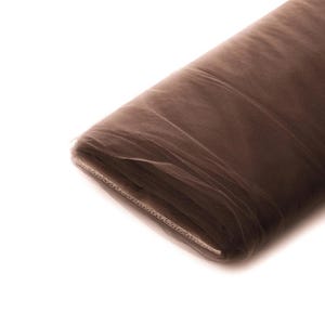 May include: A roll of brown tulle fabric. The fabric is soft and sheer, and it is perfect for crafting, decorating, or making clothing.