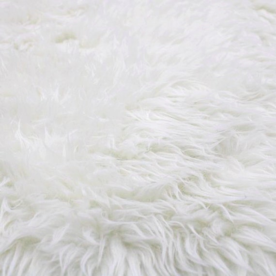 Faux Fur fabric, with a pile to it,with embroidered floral motifs, for  costumes