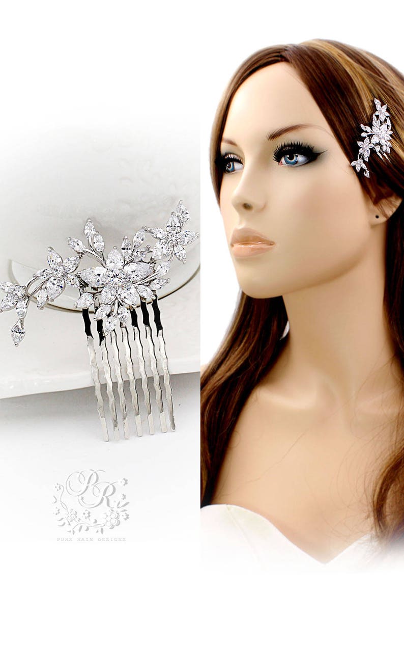May include: Silver bridal hair comb with a floral design featuring clear rhinestones. The comb has a row of teeth for easy placement in hair.