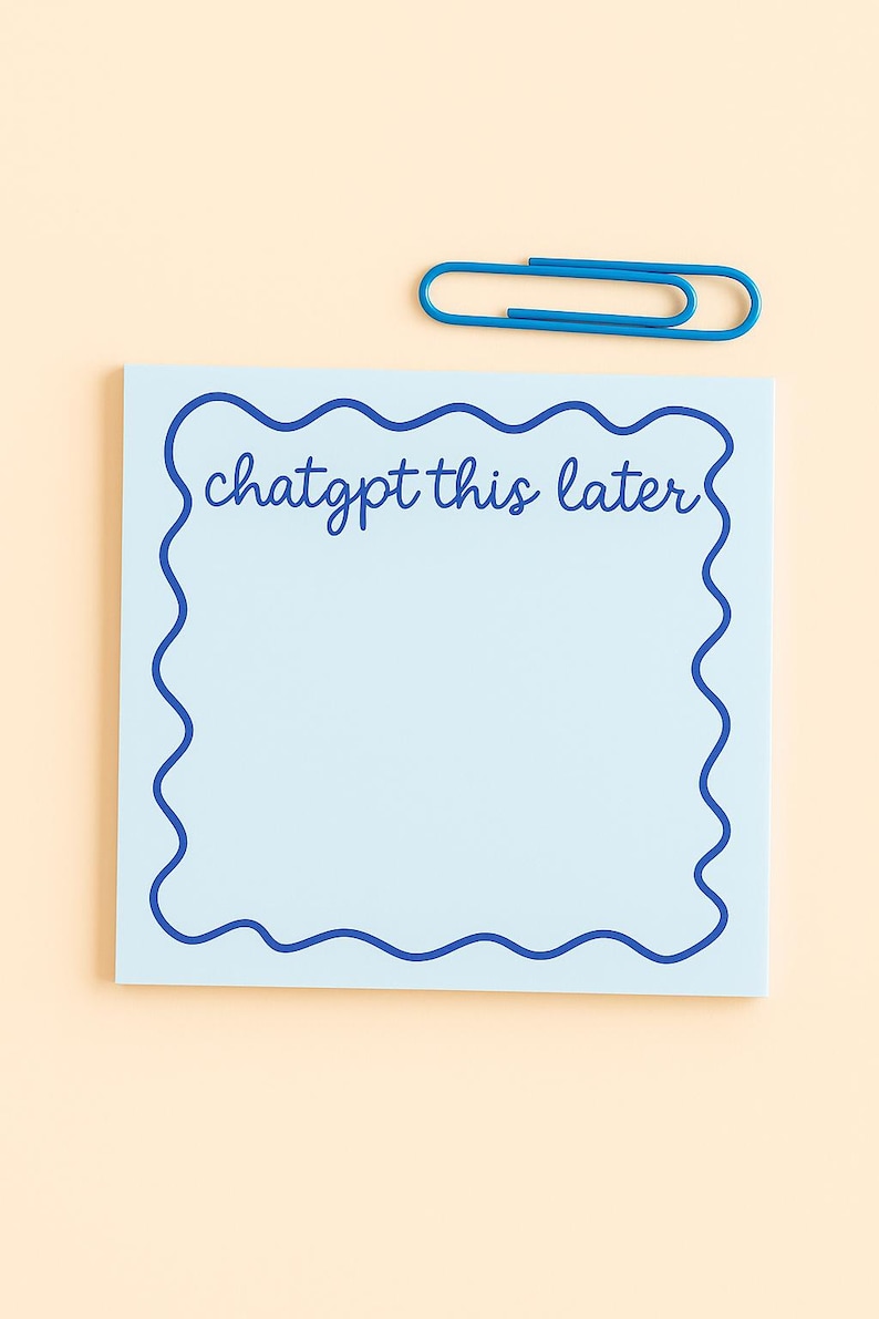 May include: A light blue sticky note with a wavy dark blue border and the handwritten text "chatgpt this later". A blue paperclip rests at the top. The background is a light peach color.