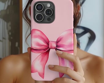 May include: A pink phone case with a watercolor pink bow design.
