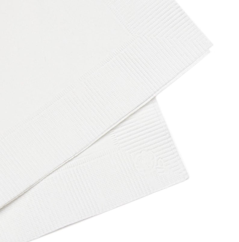 May include: Two stacked white paper napkins featuring a smooth center panel and a textured, ribbed border along the edges. The napkins are square in shape and display a clean, minimalist design with a subtle embossed detail in the corner.