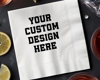 May include: White square napkin with the text "YOUR CUSTOM DESIGN HERE" in bold black letters. The napkin has a textured border and is surrounded by cocktail glasses and citrus fruit slices.