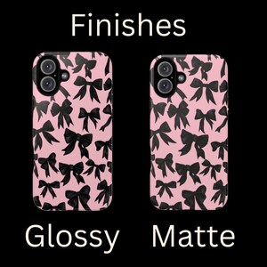 May include: Two phone cases with a pink background and black bow pattern. The case on the left is glossy and the case on the right is matte. Finishes.