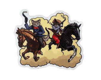 May include: A sticker featuring two cats riding horses, dressed as cowboys, and holding guns. The cat on the left wears a blue jacket and red scarf, while the other wears a brown hat and red pants. Both cats are riding through a cloud of dust.