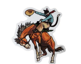 May include: A sticker featuring a cartoon cat riding a bucking bronco. The cat, wearing a cowboy hat and red neckerchief, is atop a brown horse. The cat is wearing a blue shirt and tan pants. The image has a white border.
