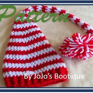 May include: A handmade red and white striped crochet hat with a long, curved tip and a matching pom-pom. The word "Pattern" is written in green script at the top, and "By Jojo's Bootique" is written at the bottom.