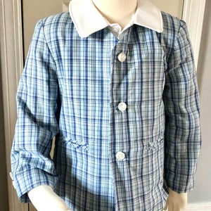 May include: A blue and white plaid blazer with a white collar and button closure. The blazer has two pockets on the front.