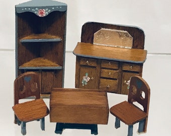 May include: A miniature dollhouse furniture set with a corner cabinet, a buffet with a mirror, a table, and two chairs. The furniture is painted in shades of brown and blue with floral accents.