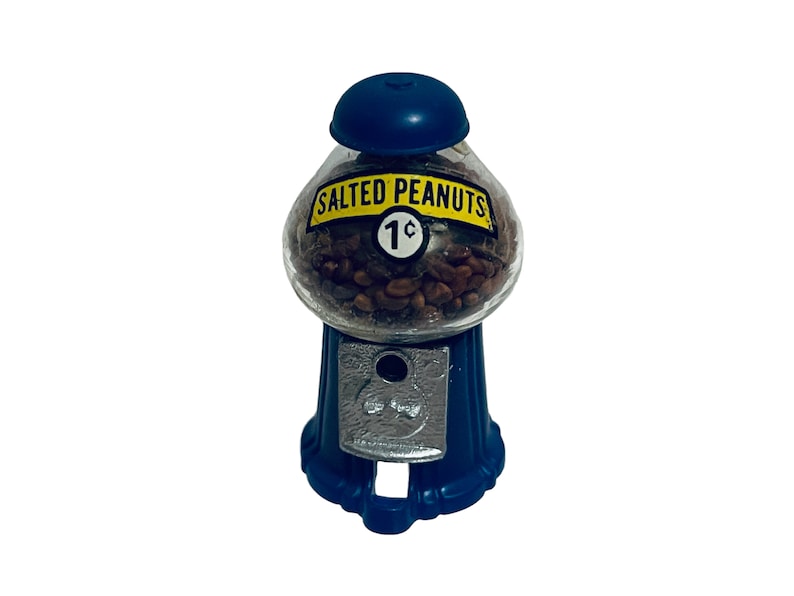 May include: A vintage-style peanut dispenser with a blue base and top. The clear glass globe is filled with salted peanuts and features a label that reads "SALTED PEANUTS 1&cent;". The dispenser has a coin slot.