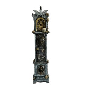 May include: A tall, weathered gray grandfather clock decoration featuring a bat perched on top, a clock face with Roman numerals, a skull accent, and a central door panel displaying a skeletal figure with reaching hands and a skull at the base.